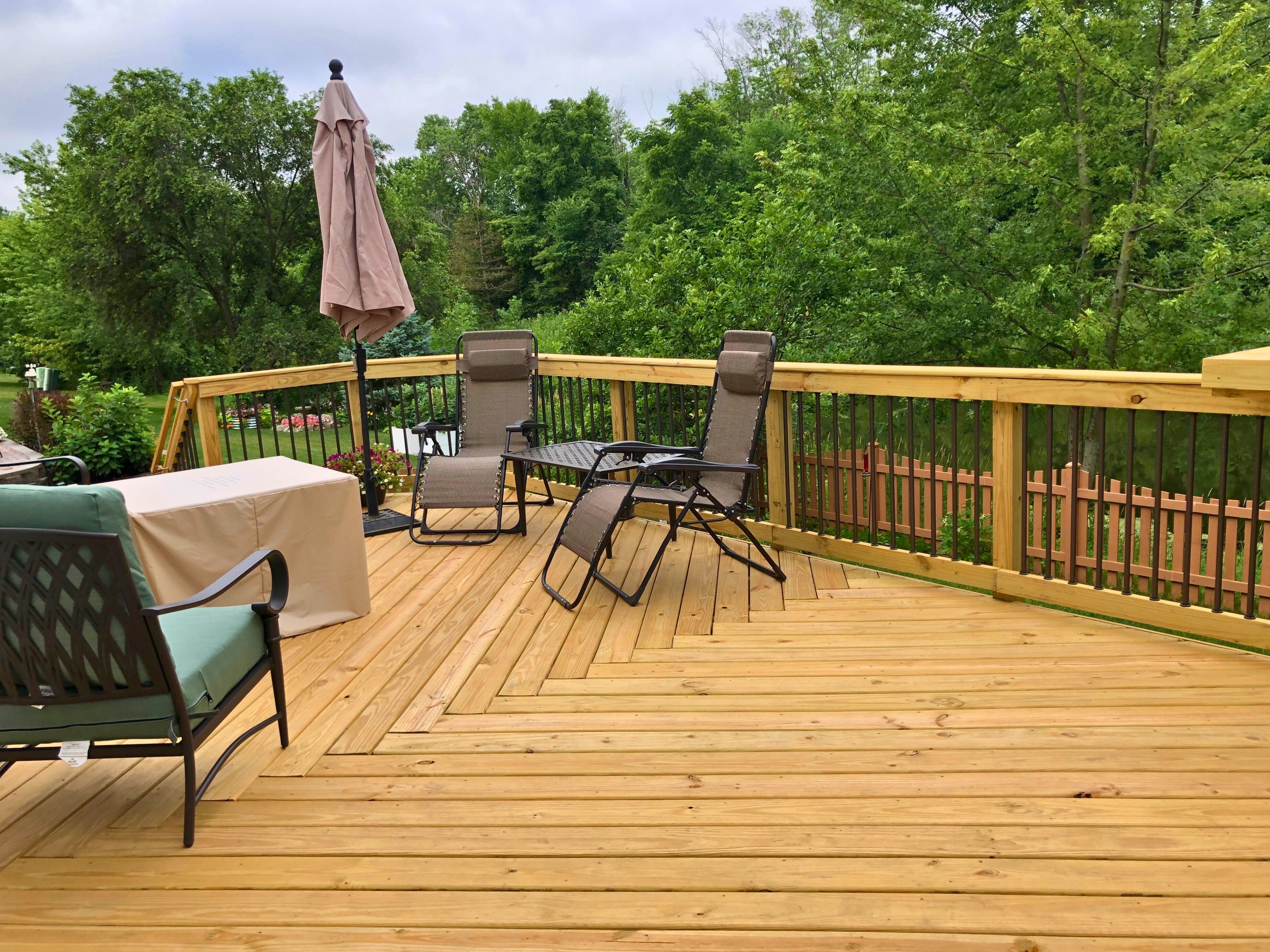 Wood deck in aurora, IL overlooking green trees.